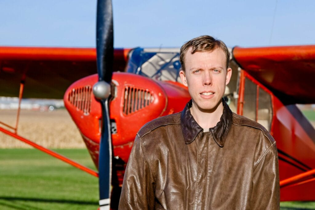 John Chvatal standing in front of a 1941 Taylorcraft.